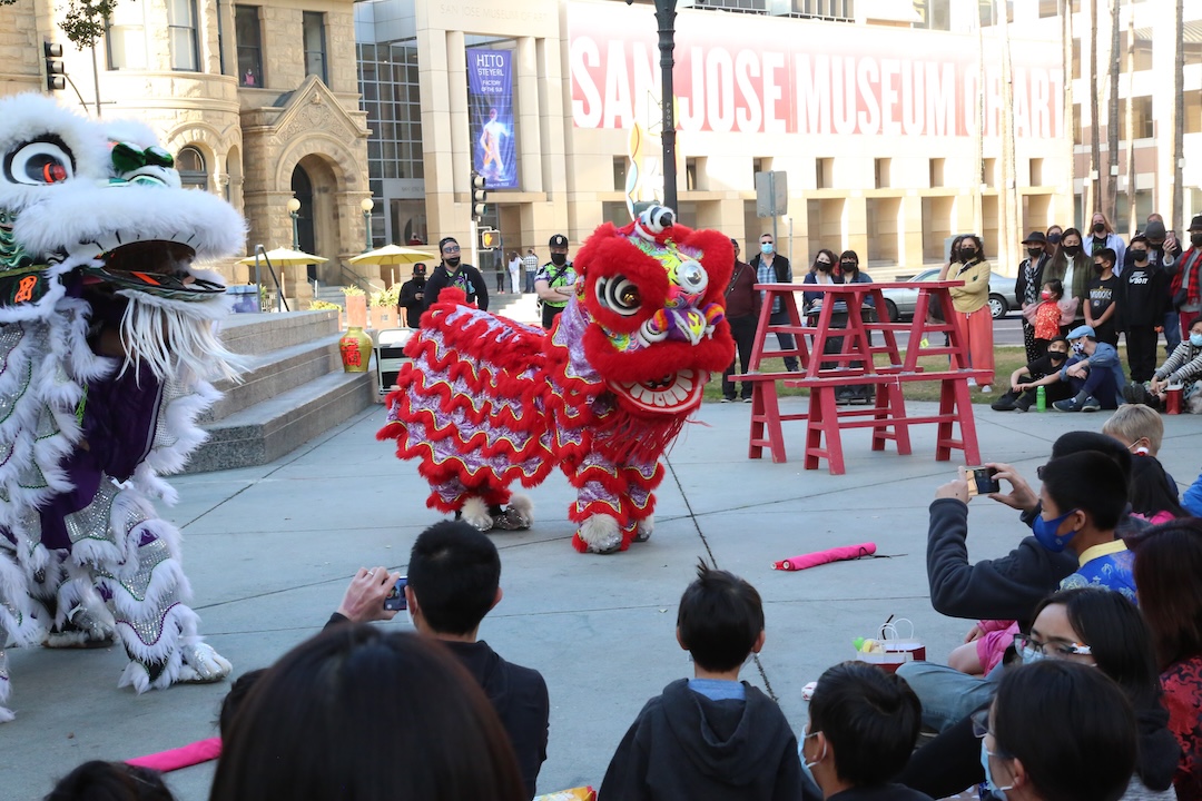 lion dancers with a captive audience in a park