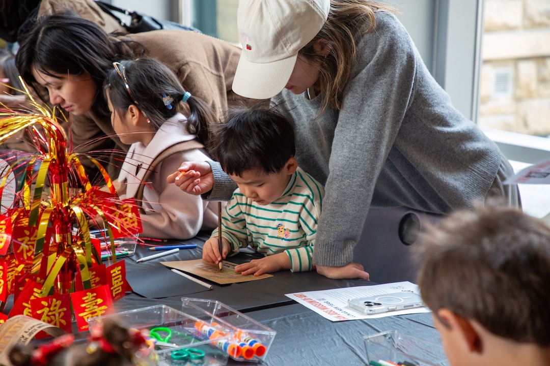 family drawing together for an art activity